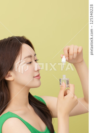 Portrait of young woman taking care of her nails 125340228