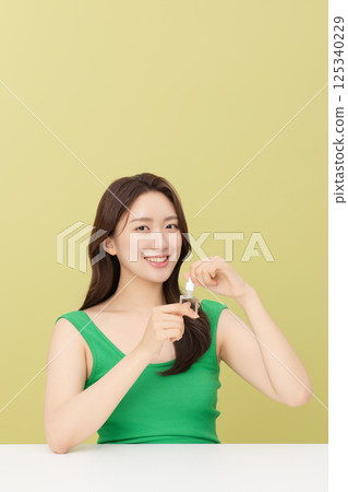 Portrait of young woman taking care of her nails 125340229