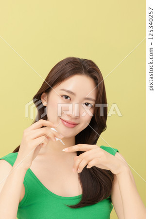 Portrait of young woman posing with nail polish Portrait of young woman posing with nail polish 125340257
