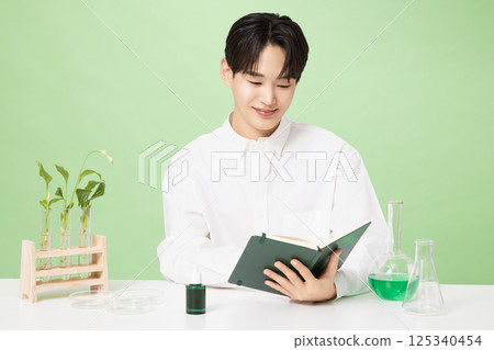 A young man posing with basic cosmetics made using plants 125340454