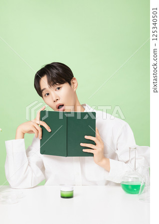 A young man posing with basic cosmetics made using plants A young man posing with basic cosmetics made using plants 125340501