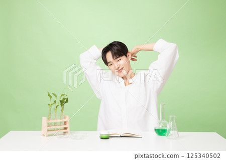 A young man posing with basic cosmetics made using plants A young man posing with basic cosmetics made using plants 125340502