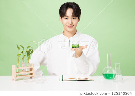 A young man posing with basic cosmetics made using plants A young man posing with basic cosmetics made using plants 125340504