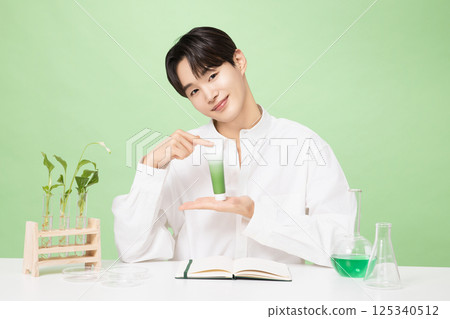 A young man posing with basic cosmetics made using plants A young man posing with basic cosmetics made using plants 125340512