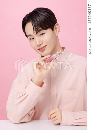 Portrait of a young man posing with a tint Portrait of a young man posing with a tint 125340587