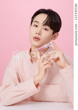 Portrait of a young man posing with a tint Portrait of a young man posing with a tint 125340596