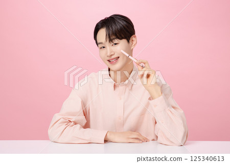 Portrait of a young man posing with his eyebrows 125340613