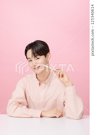 Portrait of a young man posing with his eyebrows Portrait of a young man posing with his eyebrows 125340614