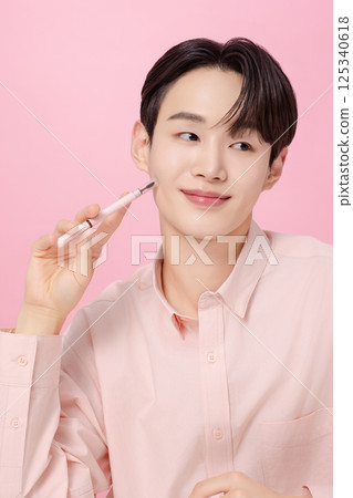 Portrait of a young man posing with his eyebrows 125340618
