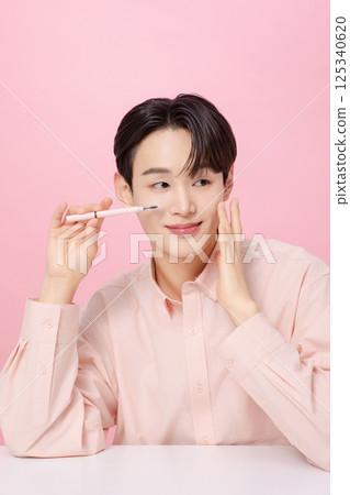 Portrait of a young man posing with his eyebrows Portrait of a young man posing with his eyebrows 125340620