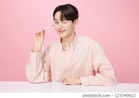 Portrait of a young man posing with his eyebrows Portrait of a young man posing with his eyebrows 125340622