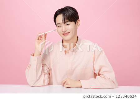 Portrait of a young man posing with his eyebrows Portrait of a young man posing with his eyebrows 125340624