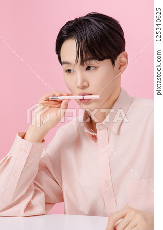 Portrait of a young man posing with his eyebrows Portrait of a young man posing with his eyebrows 125340625