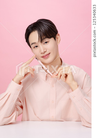 Portrait of a young man posing with his eyebrows 125340633