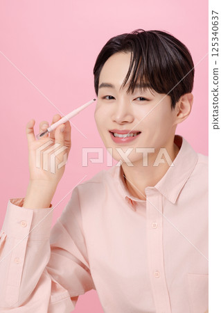 Portrait of a young man posing with his eyebrows Portrait of a young man posing with his eyebrows 125340637