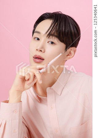 Portrait of a young man posing with his eyebrows 125340641