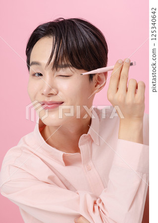 Portrait of a young man posing with his eyebrows Portrait of a young man posing with his eyebrows 125340642