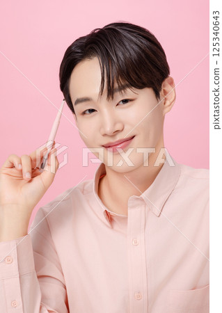 Portrait of a young man posing with his eyebrows 125340643