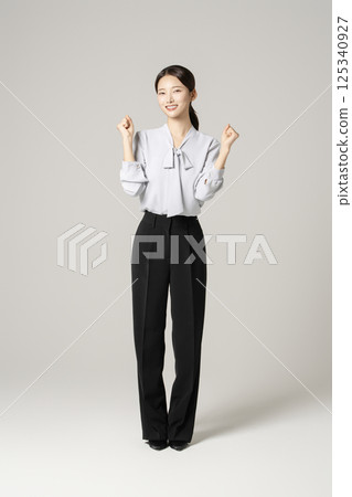 A young woman in her 20s standing in neat clothes A young woman in her 20s standing in neat clothes 125340927