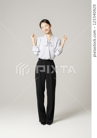 A young woman in her 20s standing in neat clothes A young woman in her 20s standing in neat clothes 125340929