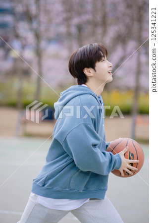 Portrait of a young man playing basketball in the park Portrait of a young man playing basketball in the park 125341221