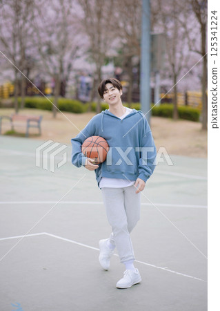 Portrait of a young man playing basketball in the park Portrait of a young man playing basketball in the park 125341224