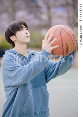 A young couple enjoying a basketball date in the park 125341231