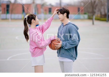 A young couple enjoying a basketball date in the park A young couple enjoying a basketball date in the park 125341255