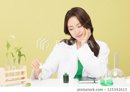 A woman wearing a doctor's gown is holding eco-friendly cosmetics A woman wearing a doctor's gown is holding eco-friendly cosmetics 125341613