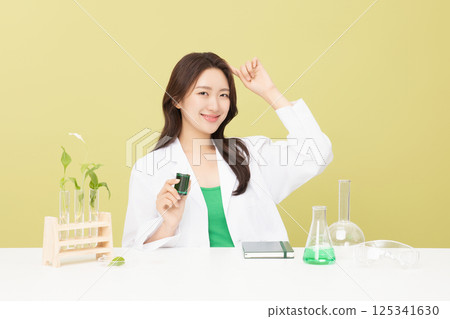 A woman wearing a doctor's gown is holding eco-friendly cosmetics A woman wearing a doctor's gown is holding eco-friendly cosmetics 125341630