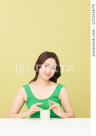 A pretty woman holding eco-friendly basic cosmetics A pretty woman holding eco-friendly basic cosmetics 125341679