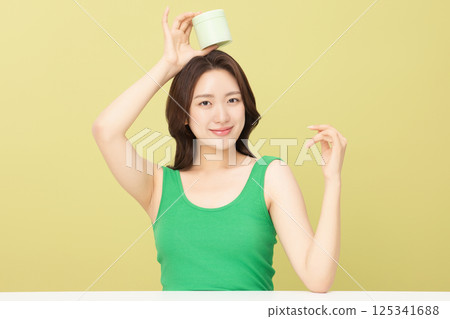 A pretty woman holding eco-friendly basic cosmetics A pretty woman holding eco-friendly basic cosmetics 125341688