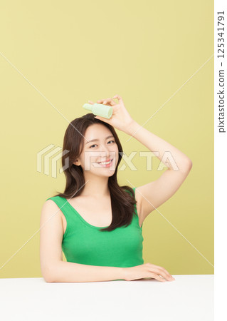 A pretty woman holding eco-friendly basic cosmetics A pretty woman holding eco-friendly basic cosmetics 125341791