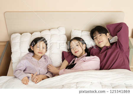 A family gathered in the living room doing their own thing 125341869