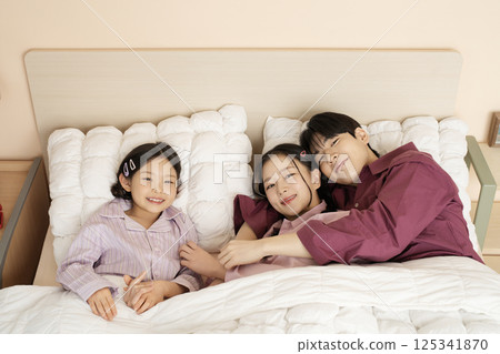 A family gathered in the living room doing their own thing 125341870