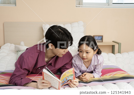 A family wearing sunglasses and playing while unpacking their suitcases 125341943