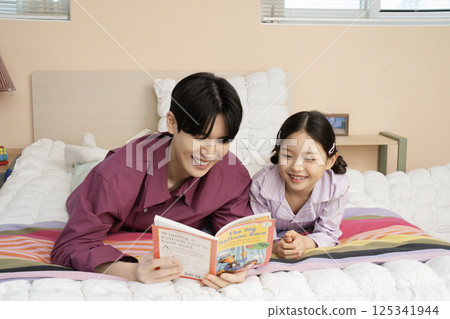 A family wearing sunglasses and playing while unpacking their suitcases 125341944
