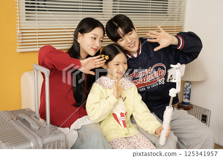 A family unpacking their suitcases at their accommodation A family unpacking their suitcases at their accommodation 125341957