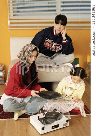 A family standing together holding hands 125341965