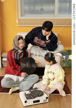 A family standing together holding hands 125341966
