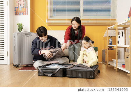 Extroverted family sitting on the sofa and taking a selfie together 125341993