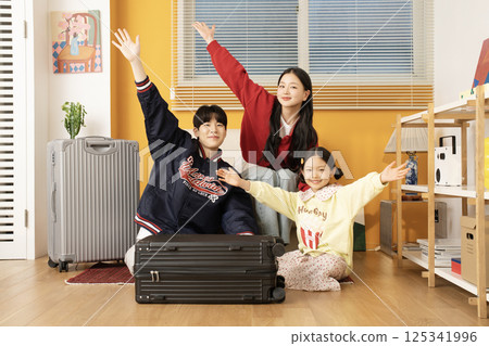 Mother and daughter sitting on the sofa and hugging their husband and father Mother and daughter sitting on the sofa and hugging their husband and father 125341996