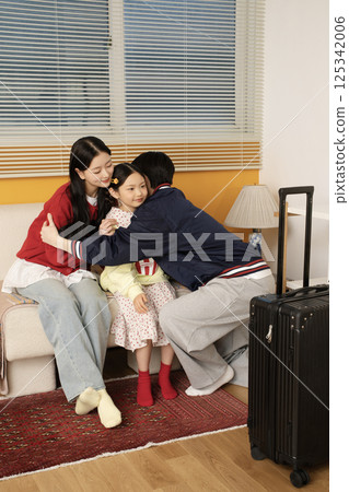 A family lying down on the floor and doing the calyx pose 125342006