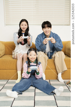 A family sitting quietly on a bed A family sitting quietly on a bed 125342033