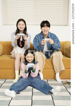 A family sitting quietly on a bed 125342034