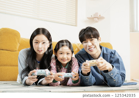 A family sitting quietly on a bed 125342035