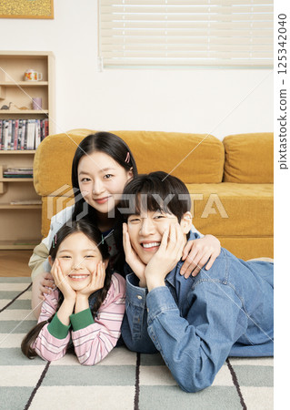 A family sitting quietly on a bed 125342040