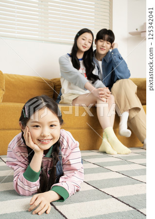A family sitting quietly on a bed 125342041