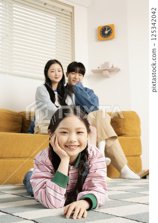 A family sitting quietly on a bed 125342042