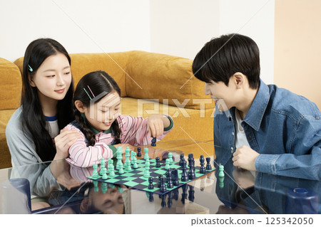 Portrait of a family lying in bed 125342050
